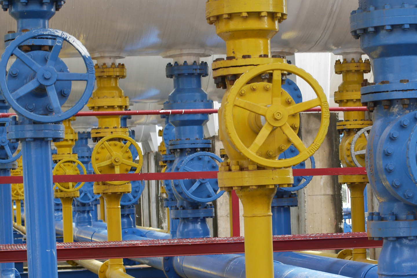 industrial blue and yellow machinery used in gas production