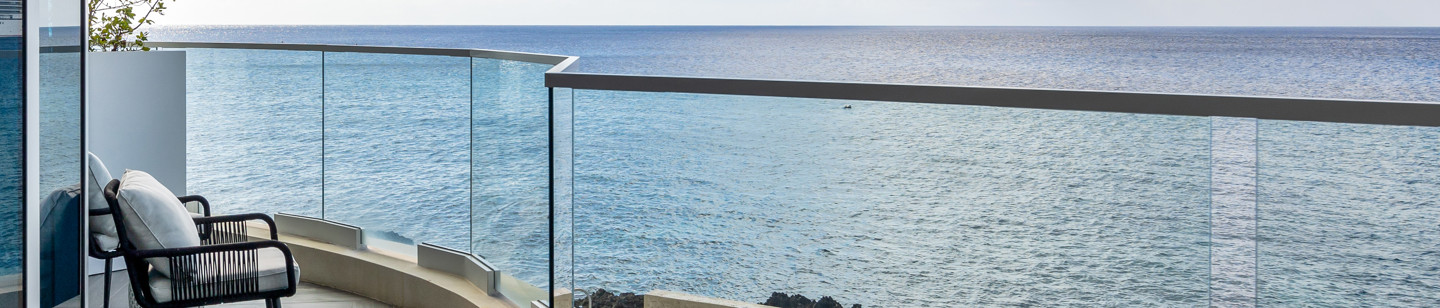 Balcony with chair on it with view of the sea 