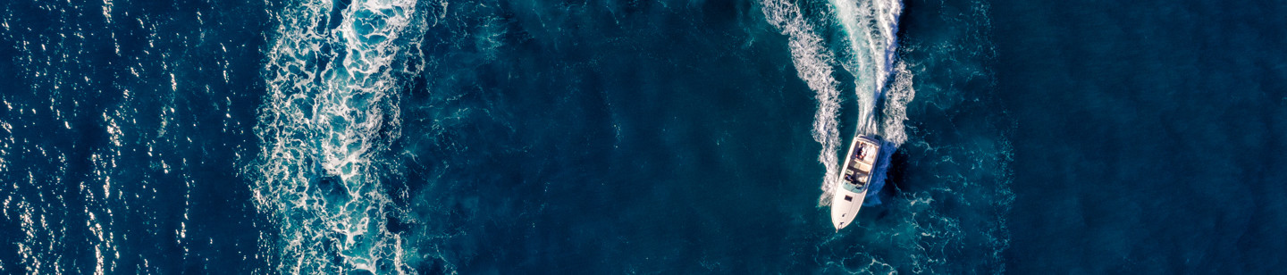 Aerial shot of speedboat creating 'O' in the sea